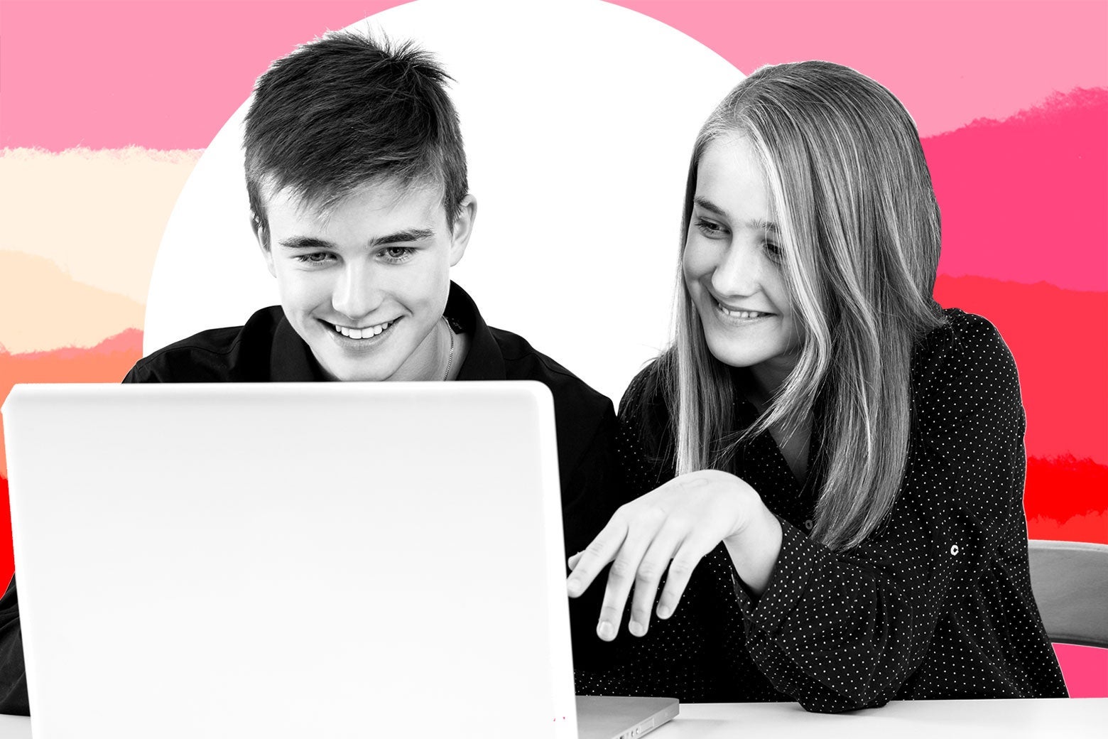 Teen boy and girl doing homework on a laptop.