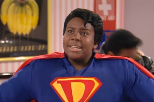 A young Kenan Thompson wears a Superman-like suit with a D on the chest.