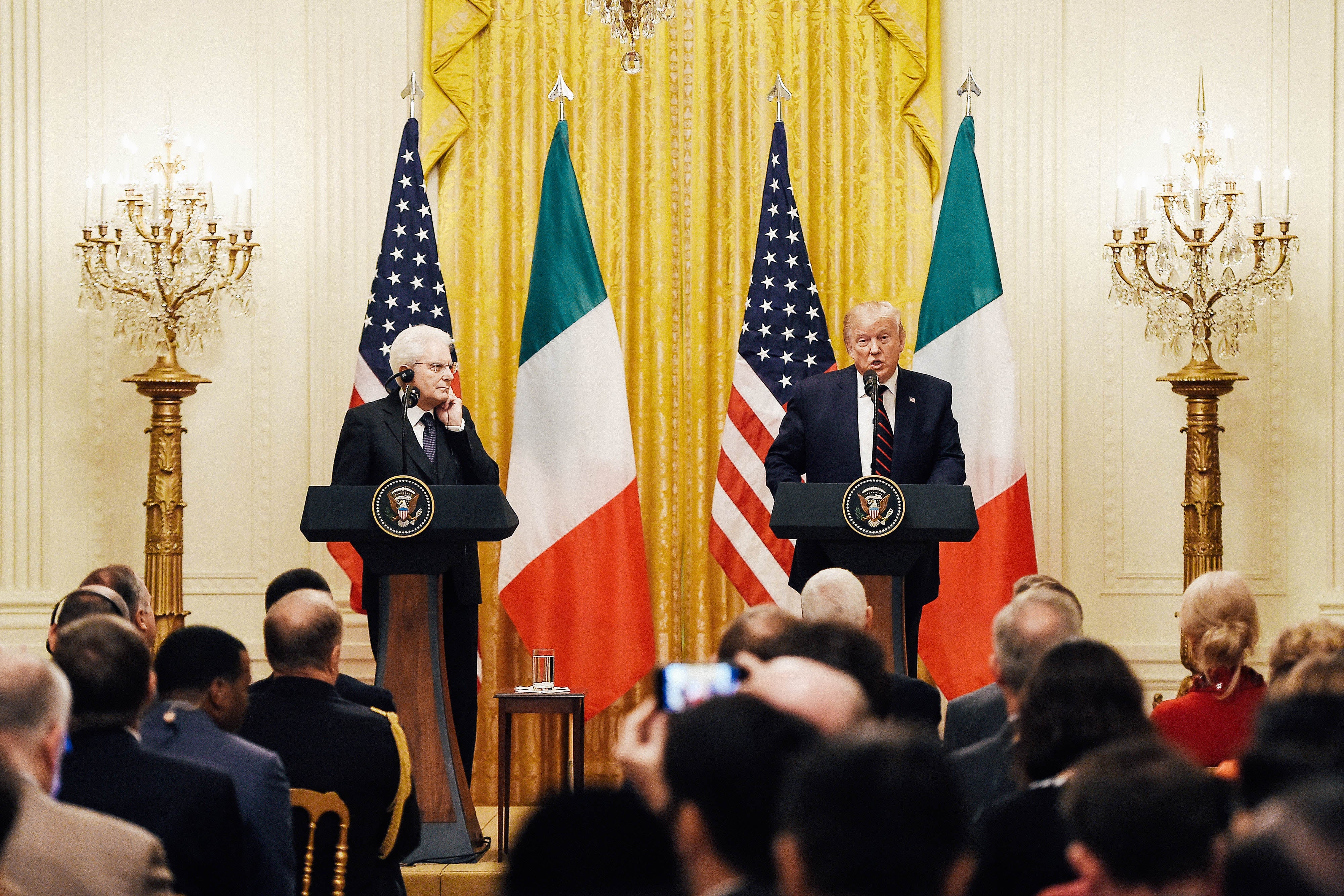 Trump and the Italian president at podiums in front of American and Italian flags.