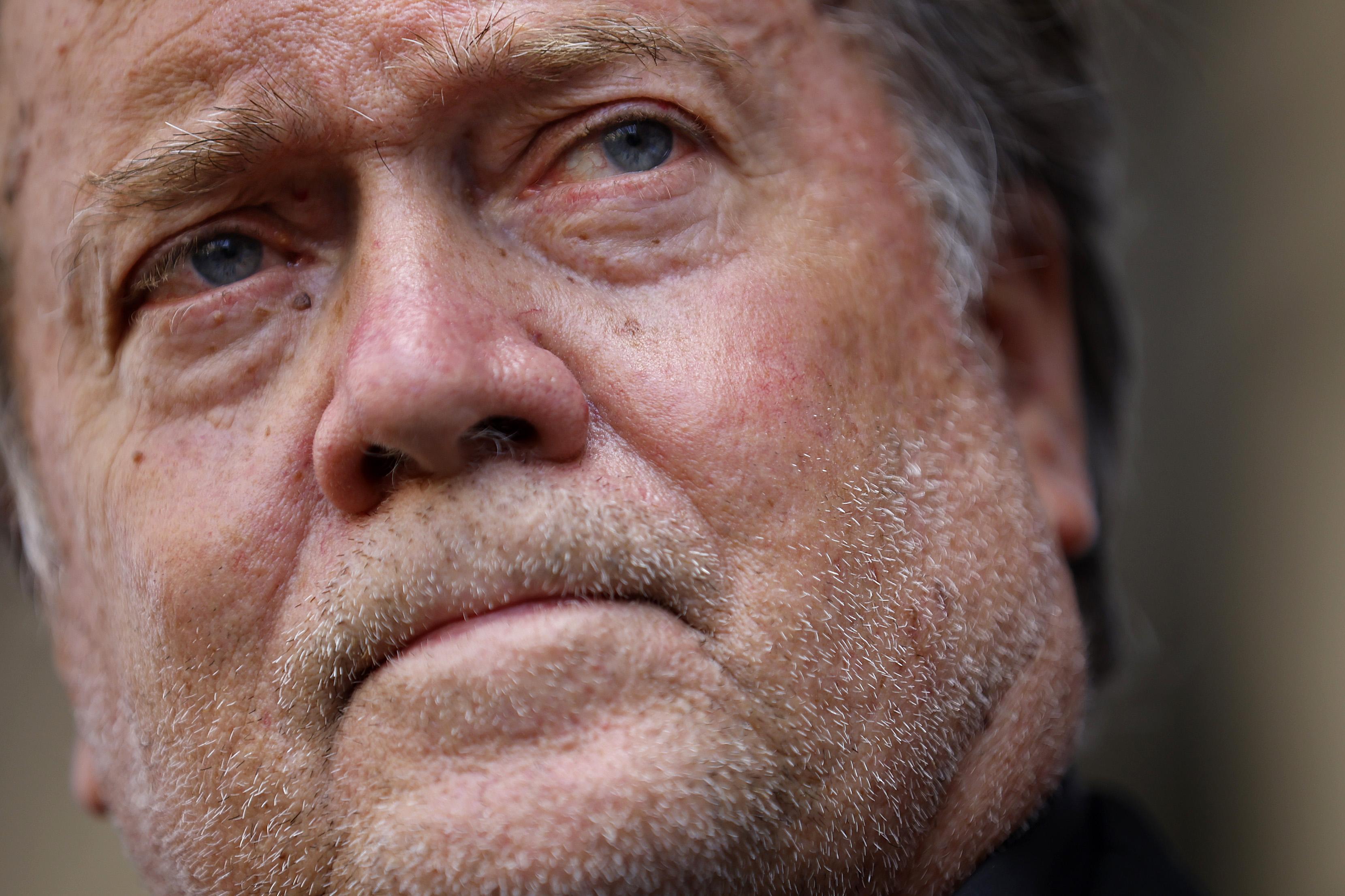 A close-up of Bannon's stubbly, pock-marked face looking extremely sad.