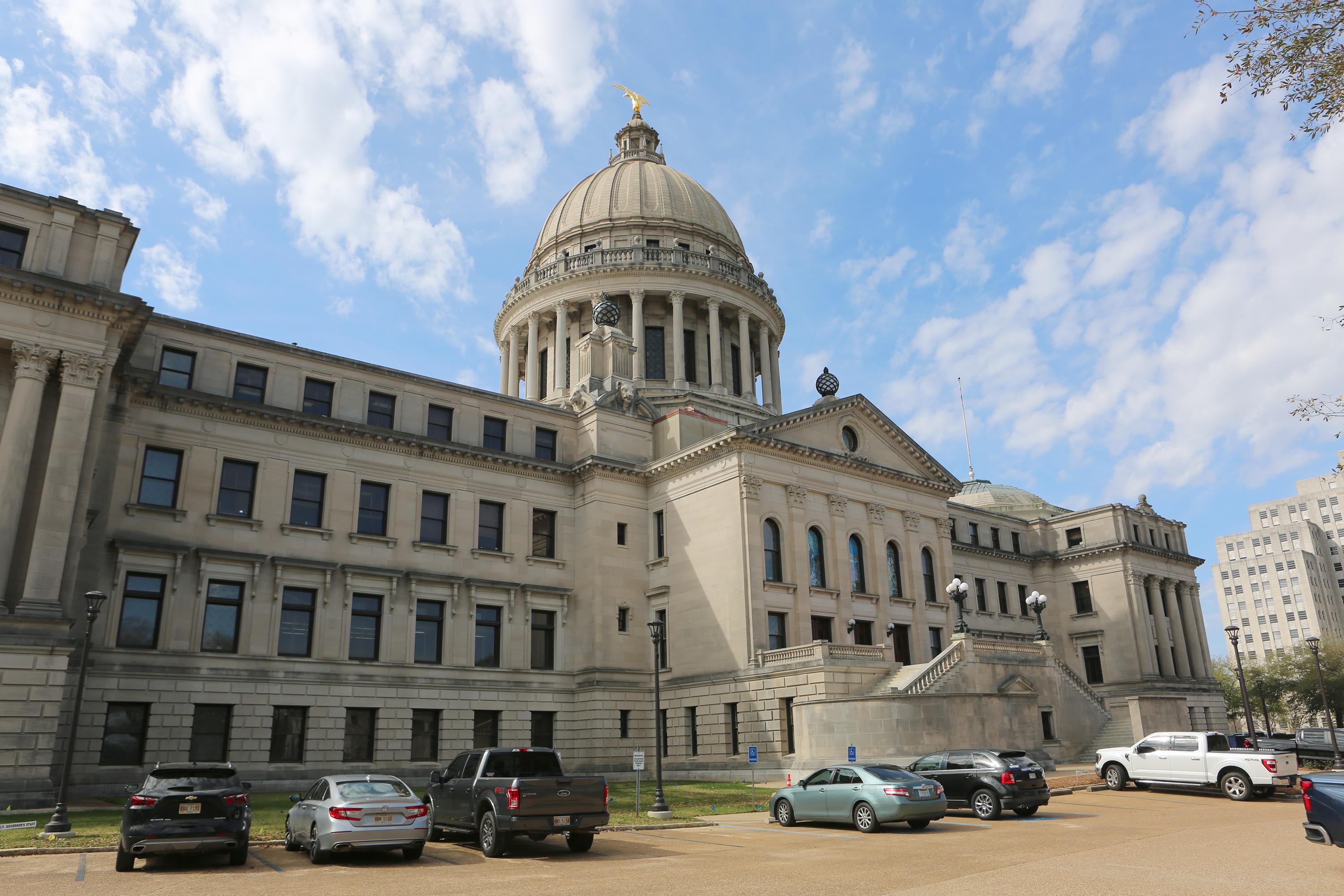 The Mississippi State Capitol, with cars parked out front