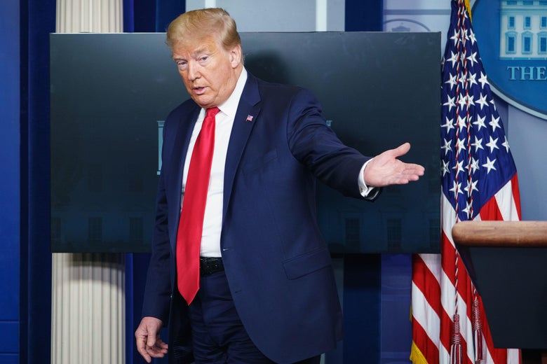 President Trump gestures as he leaves the press briefing room at the White House.