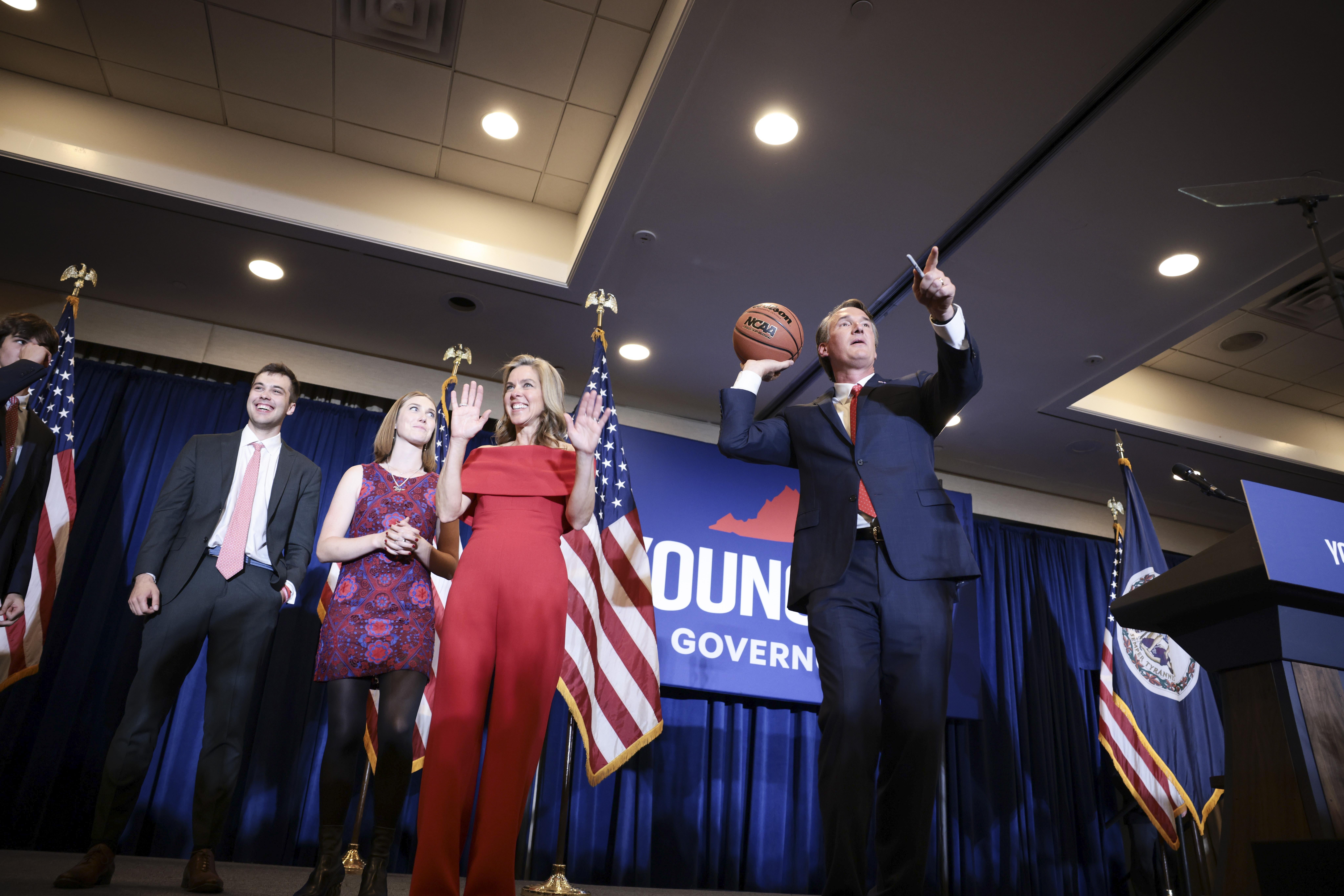 CHANTILLY, VIRGINIA - NOVEMBER 02 :Virginia Republican gubernatorial candidate Glenn Youngkin passes an autographed basketball into the crowd with his family at his election night rally at the Westfields Marriott Washington Dulles on November 02, 2021 in Chantilly, Virginia. Virginians went to the polls Tuesday to vote in the gubernatorial race that pitted Youngkin against Democratic gubernatorial candidate, former Virginia Gov. Terry McAuliffe. (Photo by Anna Moneymaker/Getty Images)