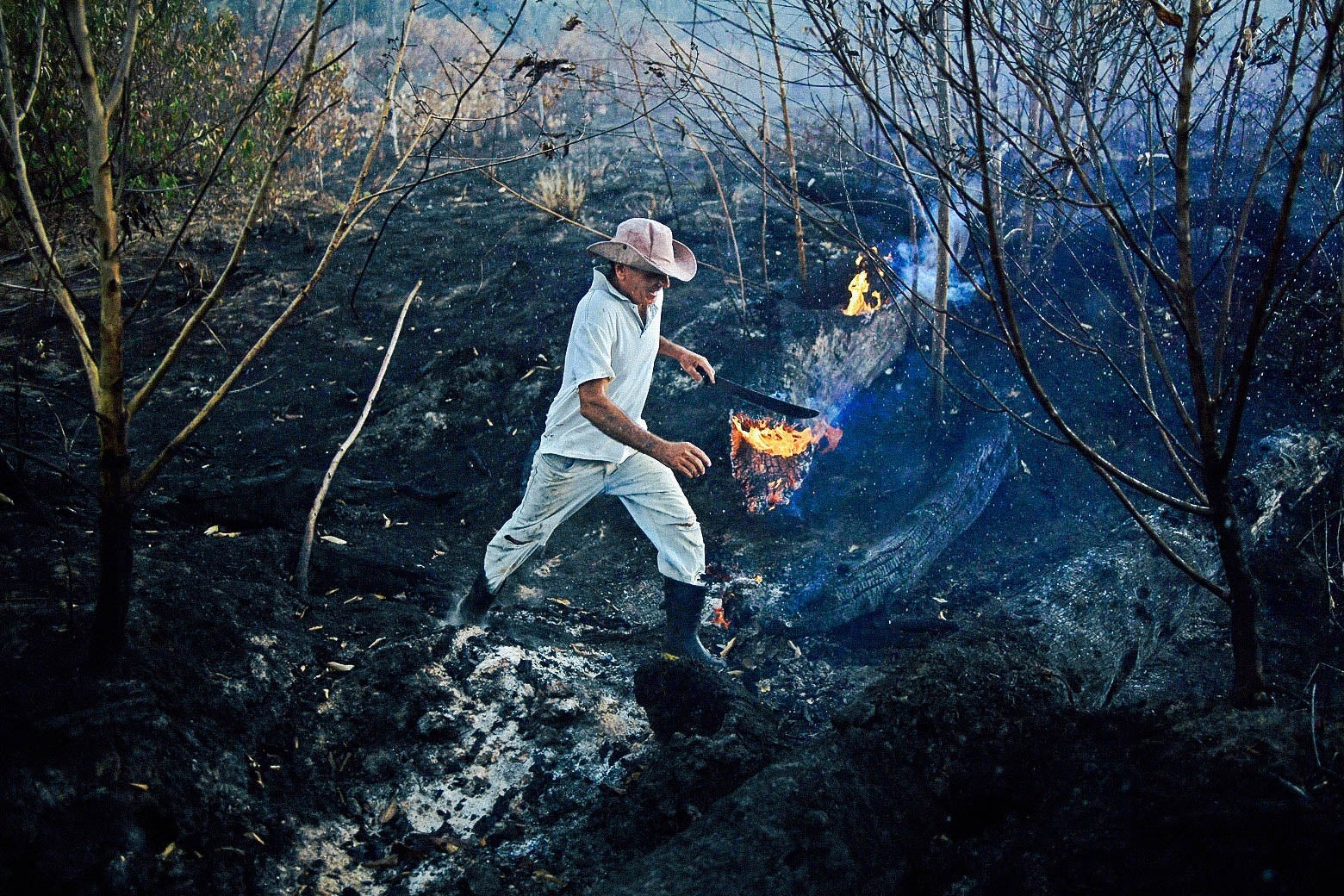 A farmer is seen at a burned area of the Amazon rainforest.