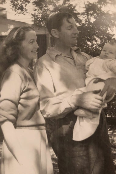 Elva P. Higgins with husband and first child.