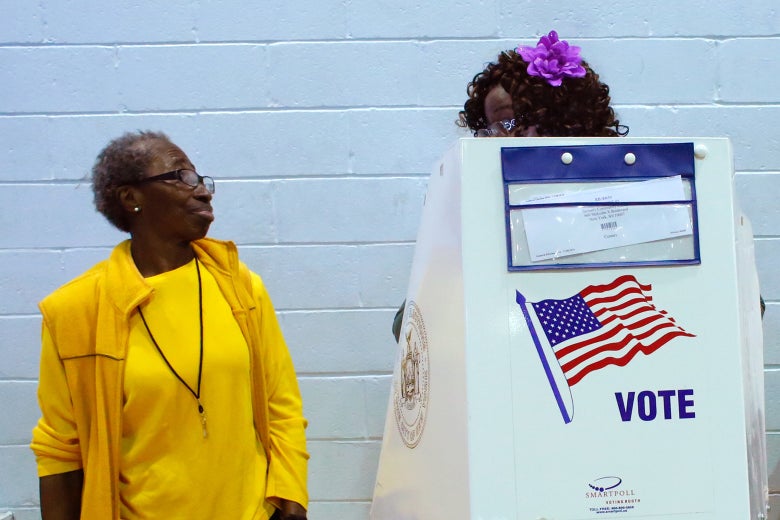 A voter asks an election worker a question as she votes at Samuels Community Center in the presidential election November 8, 2016 in the Harlem neighborhood of New York City.
