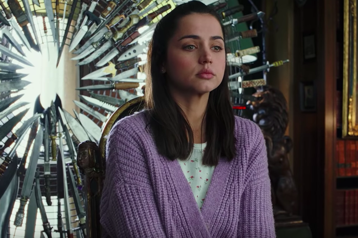 Ana de Armas in a purple sweater.