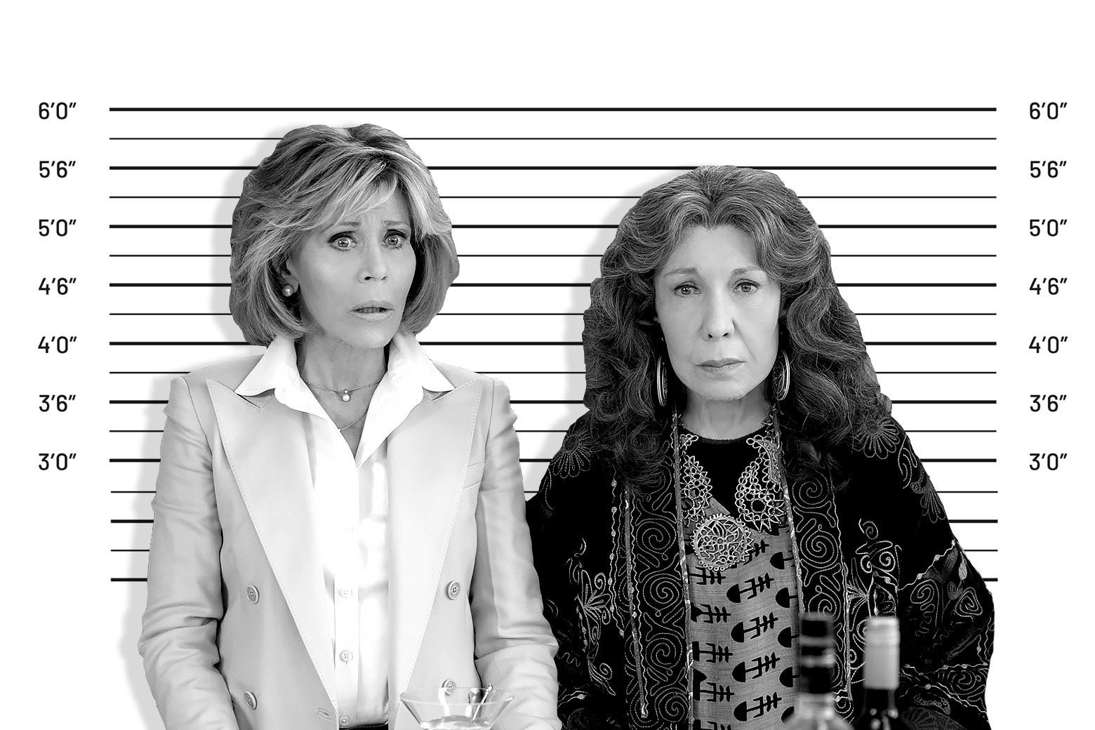 A mugshot-style black-and-white photo shows Jane Fonda and Lily Tomlin standing in front of a latitudinal height marker, their hair big, their clothes bourgie, their expressions shocked and disappointed