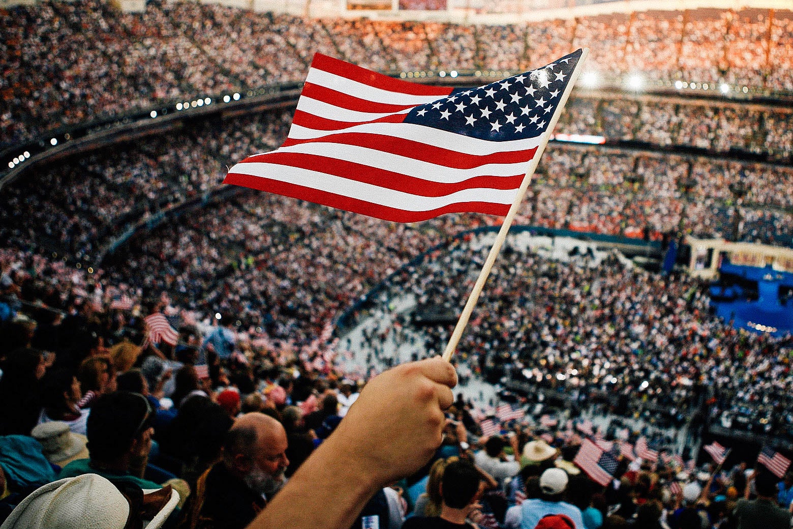 A person holding the American flag at the 2008 Democratic National Convention.