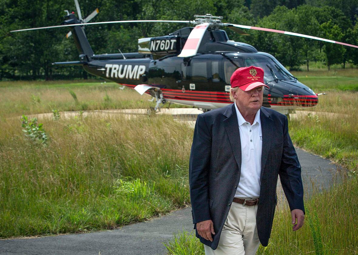 Donald Trump walks past his helicopter.