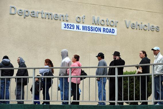 People wait in line outside of the State of California Department of Motor Vehicles in Los Angeles, California on February 13, 2009.
