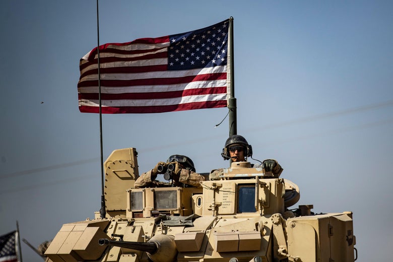 A soldier mans the turret of a Bradley Fighting Vehicle.