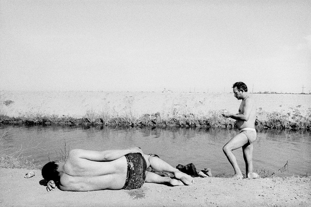 Homeless men at an irrigation canal, Mendota, California.