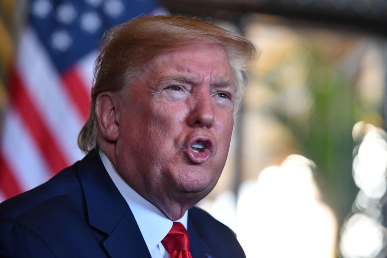 President Donald Trump answers questions from reporters after making a video call to the troops stationed worldwide at the Mar-a-Lago estate in Palm Beach Florida, on December 24, 2019.