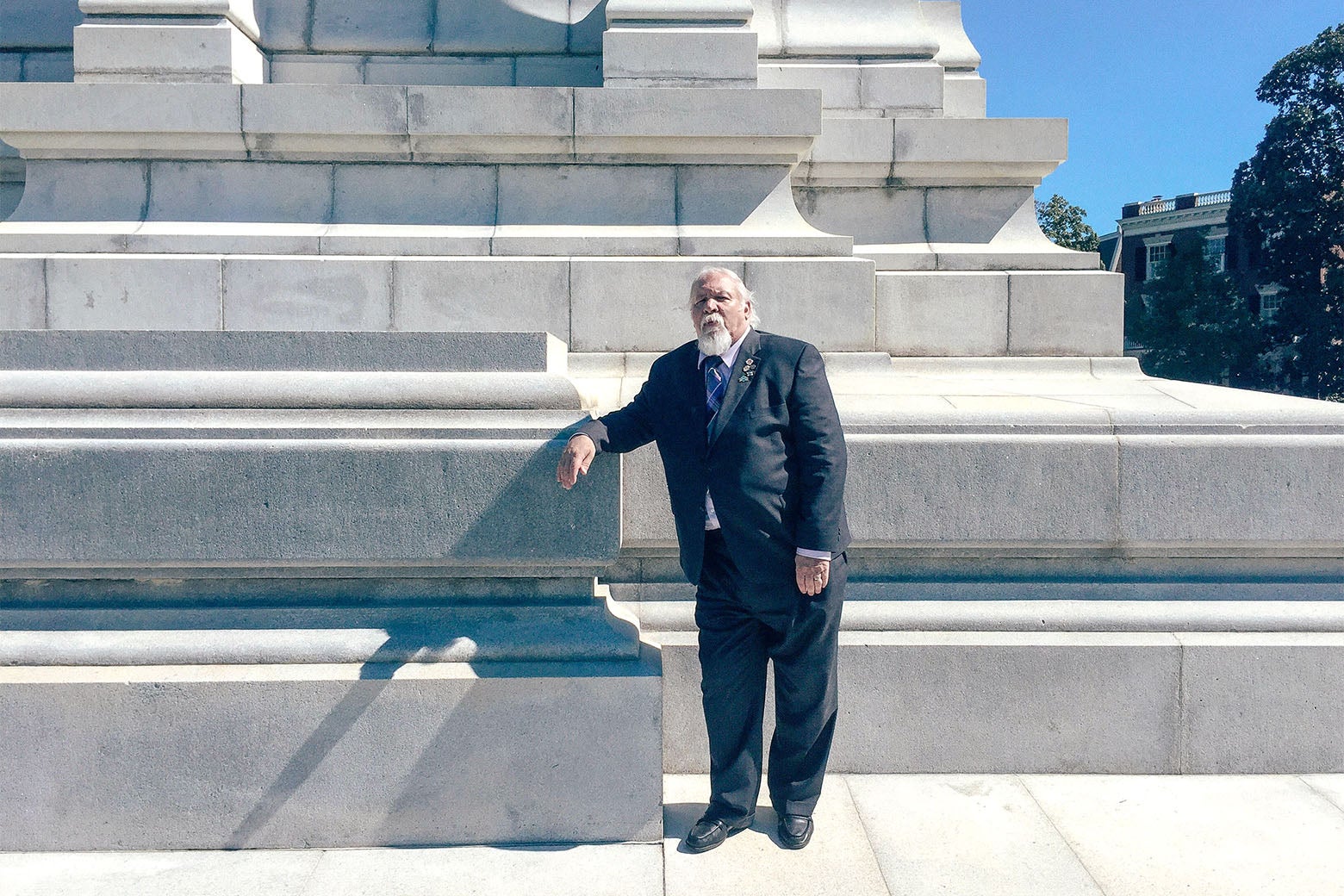 Frank Earnest of the Virginia Division of the Sons of Confederate Veterans stands at the base of the Robert E. Lee memorial on Monument Avenue in Richmond, Virginia.