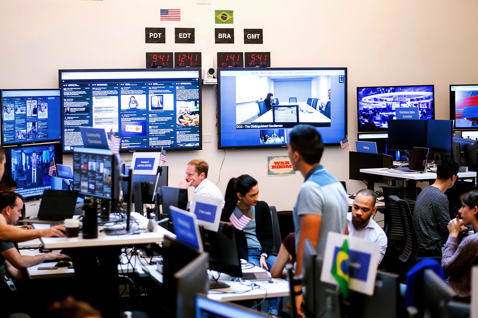 Employees work in Facebook’s “War Room” during a media demonstration.