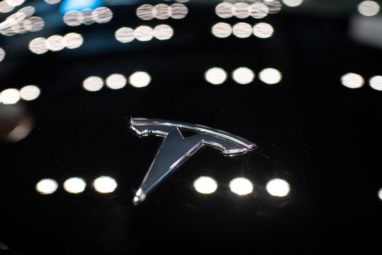 A Tesla logo is seen on a Tesla car Model 3, inside of a Tesla shop inside of a shopping Mall in Beijing on May 26, 2021. (Photo by NICOLAS ASFOURI / AFP) (Photo by NICOLAS ASFOURI/AFP via Getty Images)