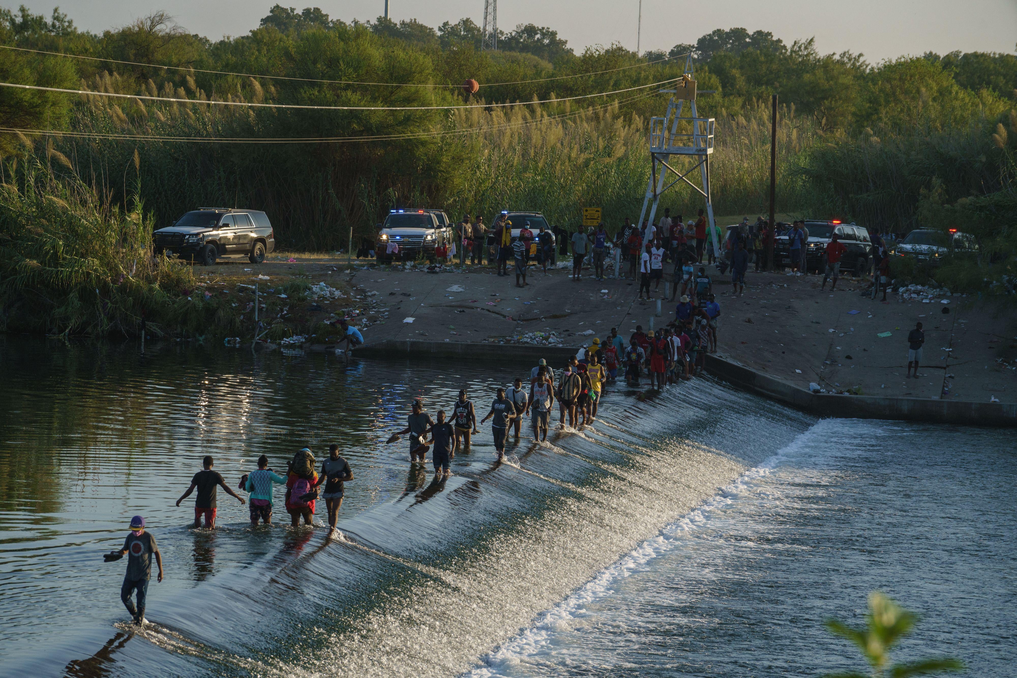 Haitian migrants cross the Rio Grande to get food and supplies near the Del Rio-Acuña Port of Entry in Ciudad Acuña, Coahuila state, Mexico on September 18, 2021. 