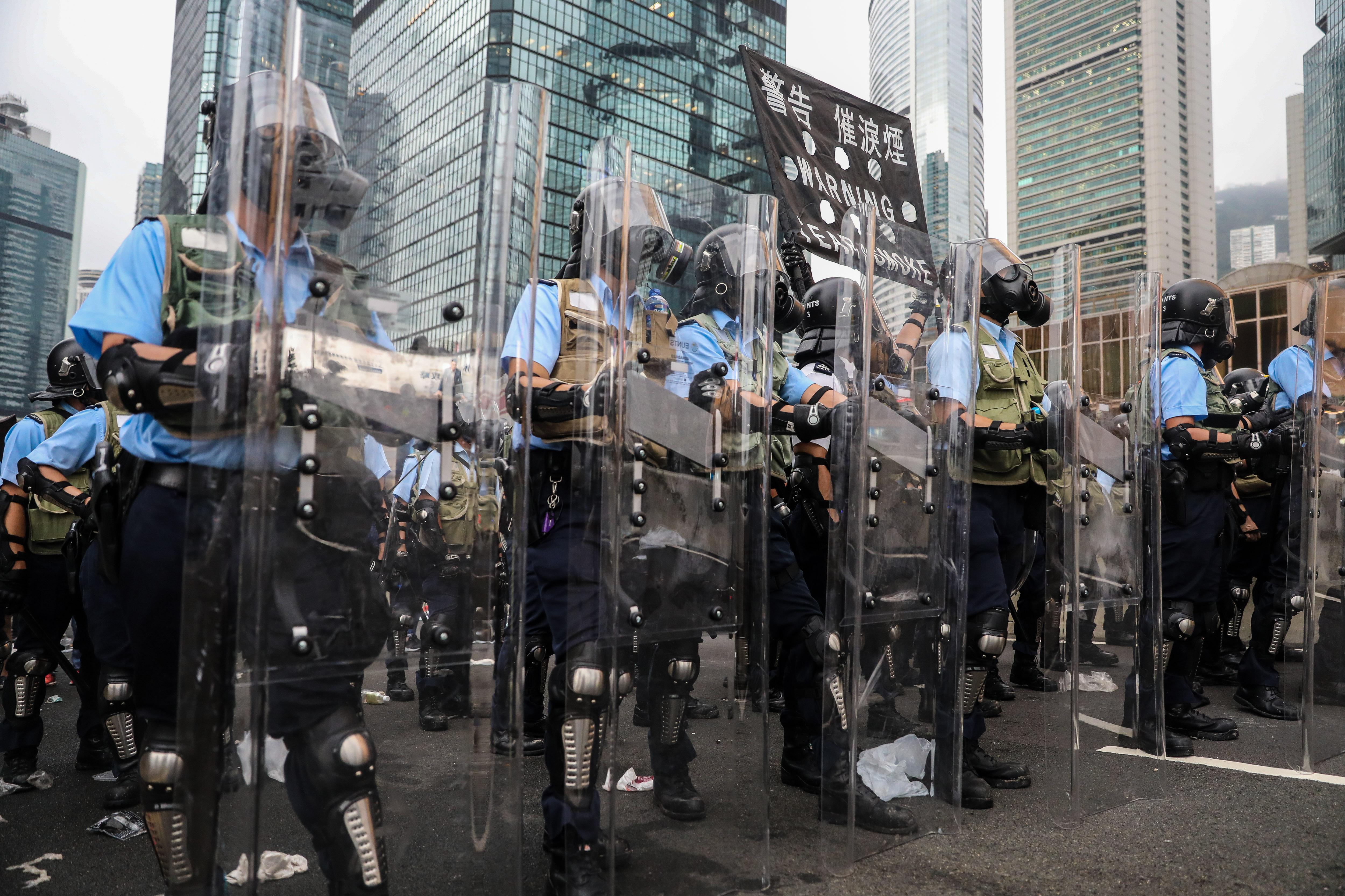 Police stand ready to use tear gas on protestors in Hong Kong.