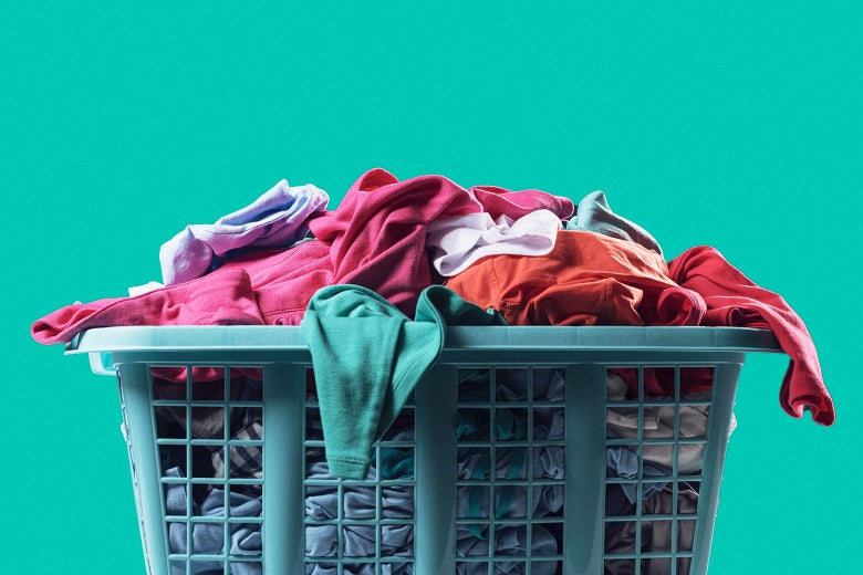 A hamper filled with unfolded clothes.