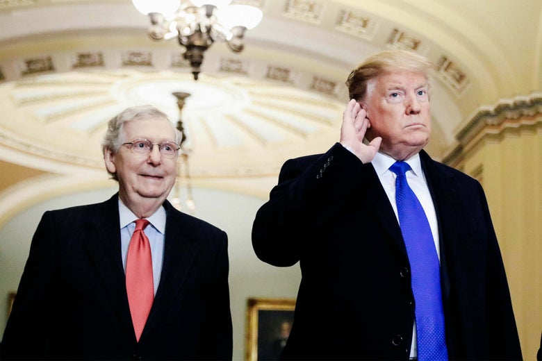 President Donald Trump listens to questions from reporters next to Senate Majority Leader Mitch McConnell.