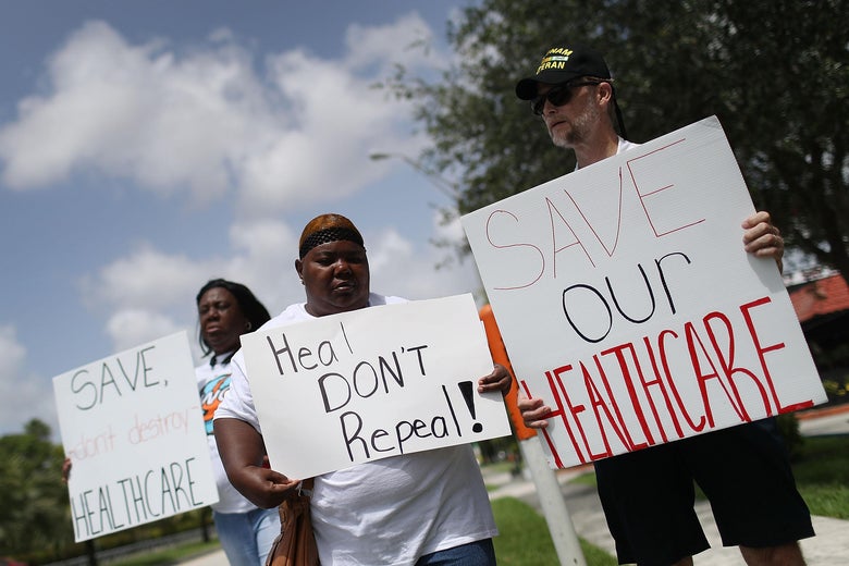 MIAMI, FL - AUGUST 03:  Protesters join together in front of the office of Rep. Carlos Curbelo (R-FL) on August 3, 2017 in Miami, Florida. The protesters are asking for Rep. Curbelo to explain his vote on the Affordable Care Act and to take a stand against what they say is 'President Donald Trump's budget that slashes Medicaid by more than $800 billion and weakens the social safety net for more than 113,000 residents in Rep. Curbelo's district who rely on Medicaid. '  (Photo by Joe Raedle/Getty Images)