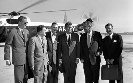 President John Kennedy poses with member of his party before air takeoff on Sept. 11, 1962.