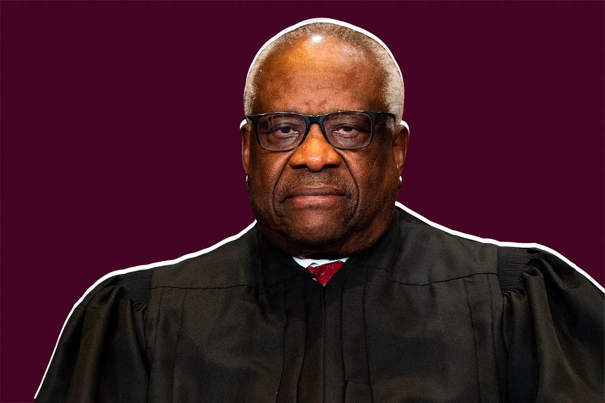 Clarence Thomas in his justice’s robe, against a cranberry-colored backdrop.