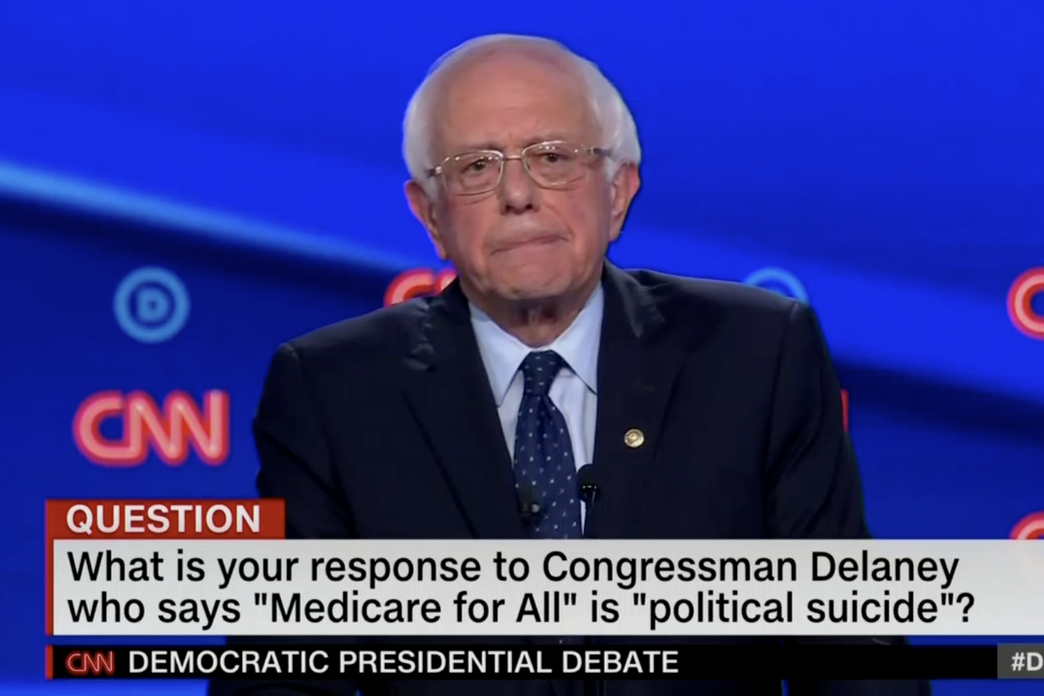 In this screengrab from CNN, Bernie Sanders prepares to answer a question during Tuesday night's debate. The banner reads: What is your response to Congressman Delaney who says "Medicare for All" is "political suicide"?