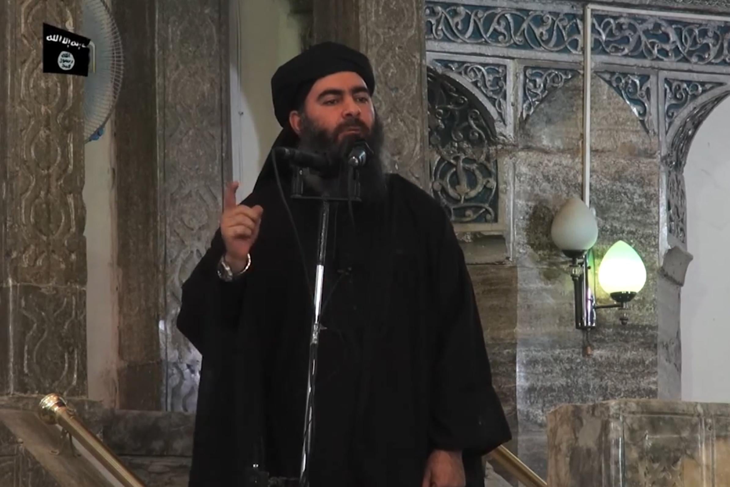In this file picture taken on July 5, 2014, an image grab taken from a propaganda video released by al-Furqan Media allegedly shows the leader of the Islamic State (IS) jihadist group, Abu Bakr al-Baghdadi, aka Caliph Ibrahim, adressing Muslim worshippers at a mosque in the militant-held northern Iraqi city of Mosul. - Kurdish-led forces announced on March 23, 2019 they had fully captured the Islamic State group's last bastion in eastern Syria and declared the total elimination of the jihadists' "caliphate."