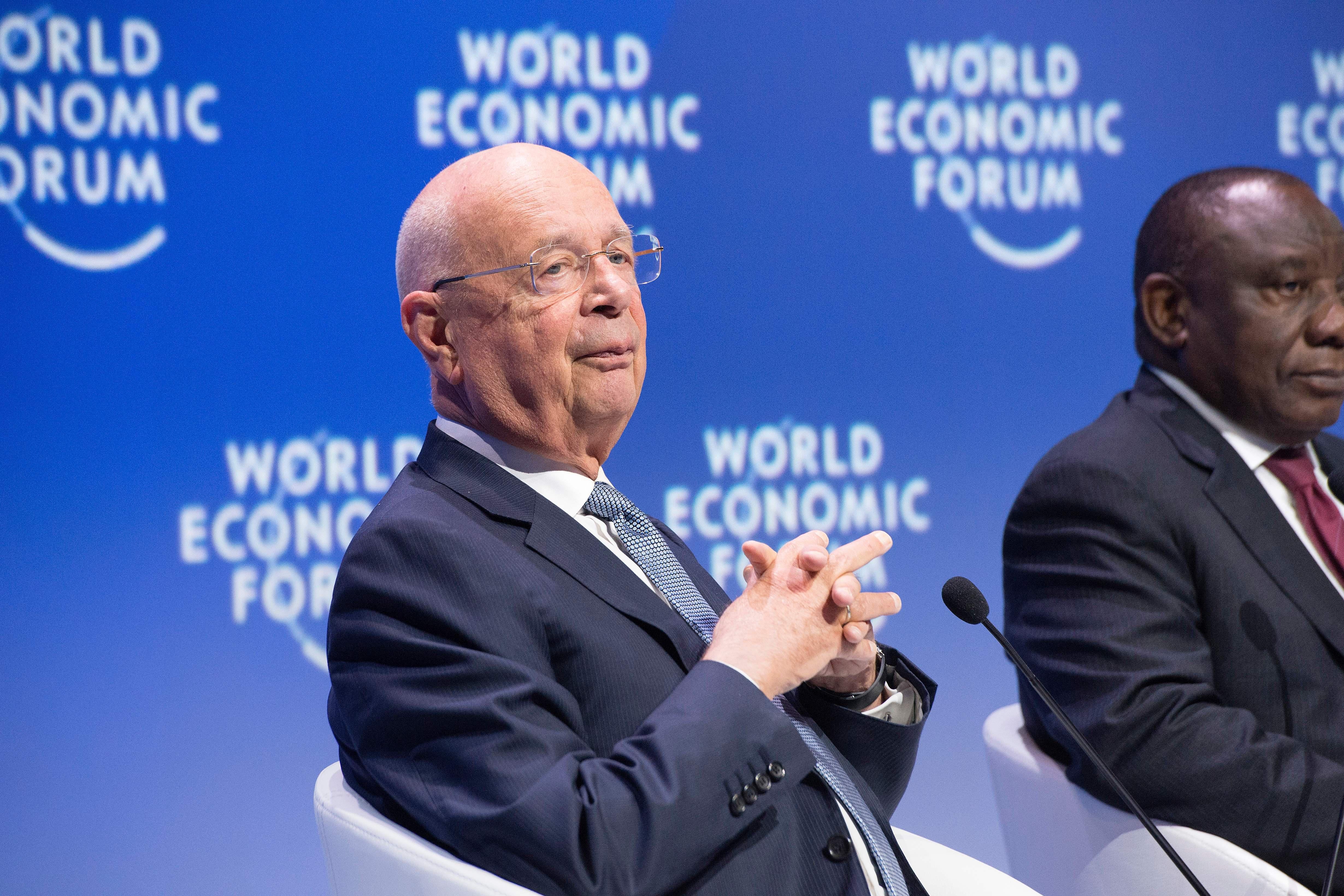 Klaus Schwab lacing his fingers in front of a mic onstage at a World Economic Forum on Africa meeting in Cape Town, South Africa, on Sept. 5.