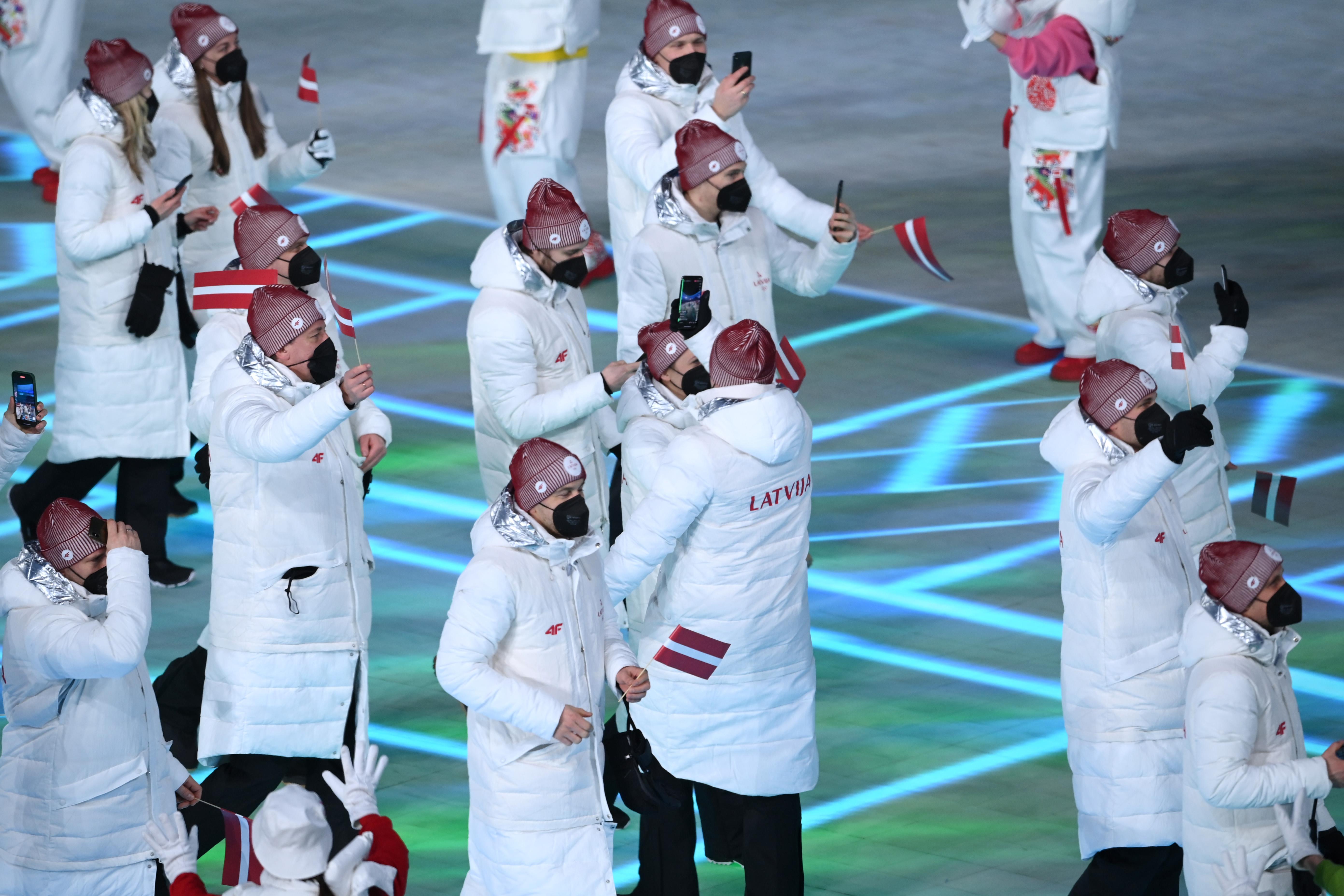 Latvia's delegation walks as a group.