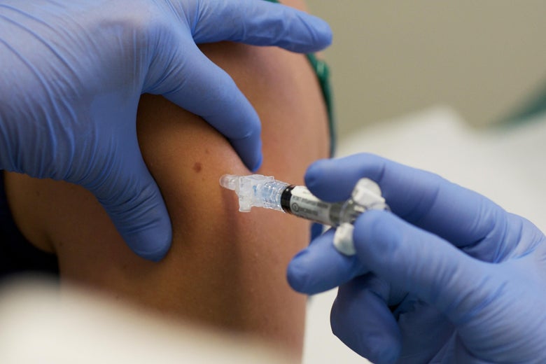 A patient is given a shot during a vaccine trial.