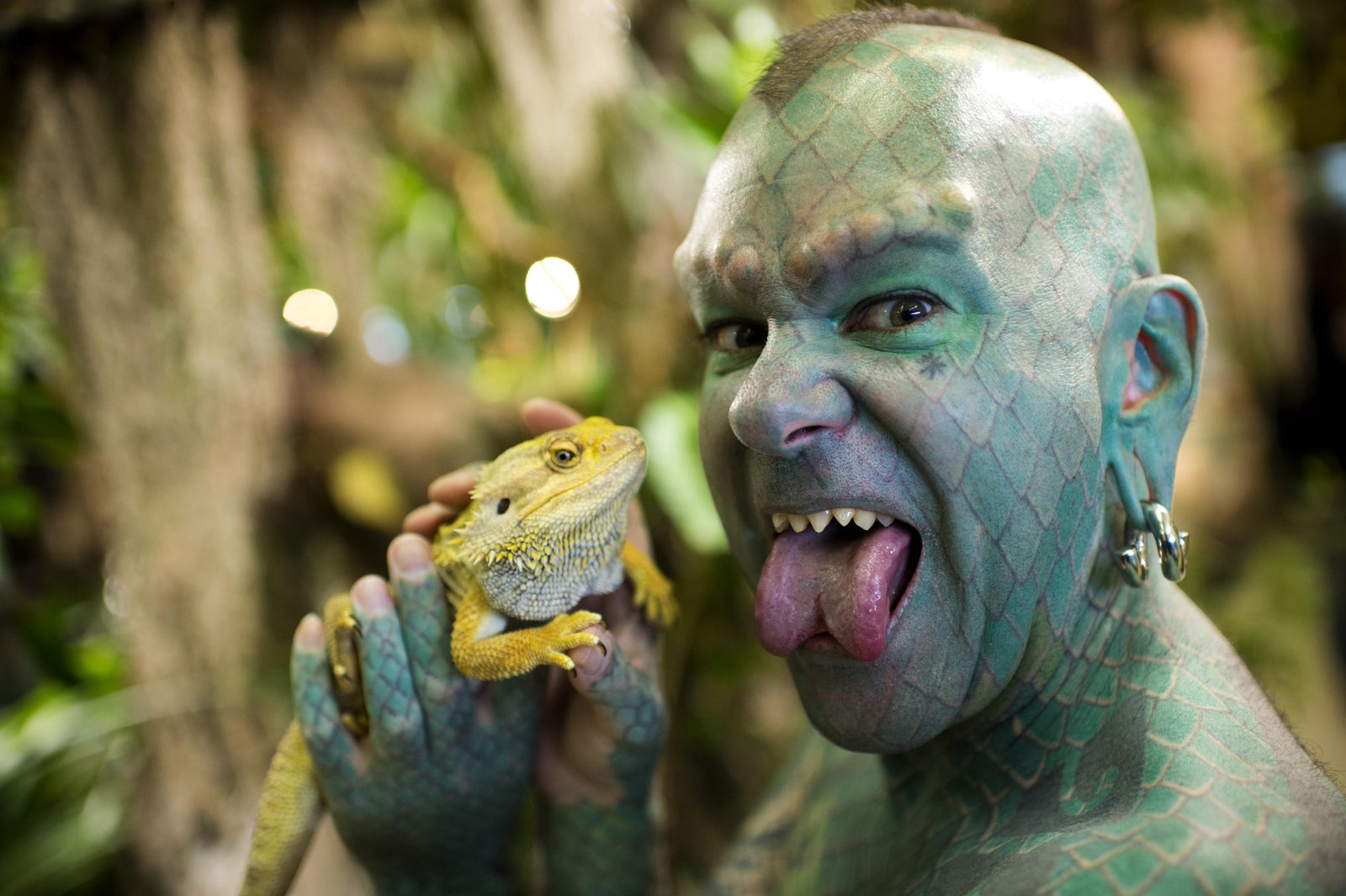 10. Eric Sprague, also known as "The Lizardman", has a full-body tattoo of green scales and has had his teeth filed into sharp points. - wide 5