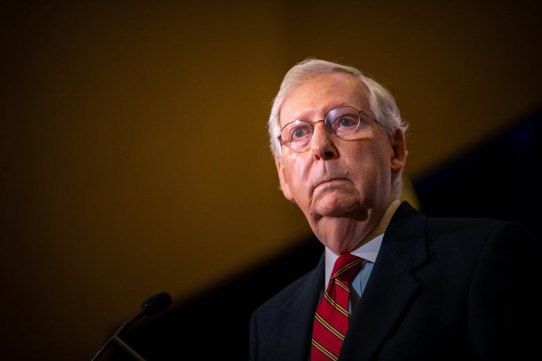 Mitch McConnell stands at a podium on election night