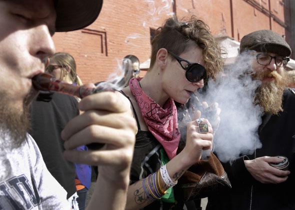 Participants smoke marijuana around 4:20 pm at the Seattle Hempfest 4/20.