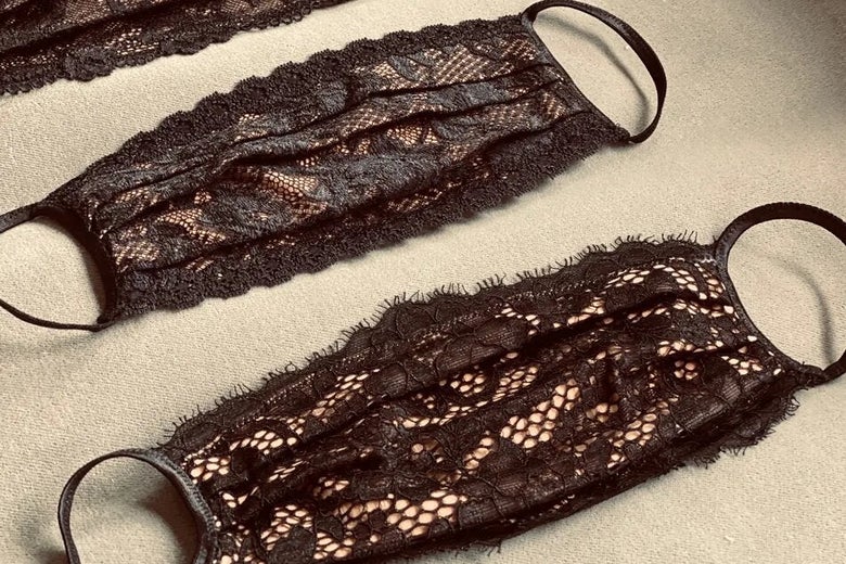 Black lace masks rest against a beige background.