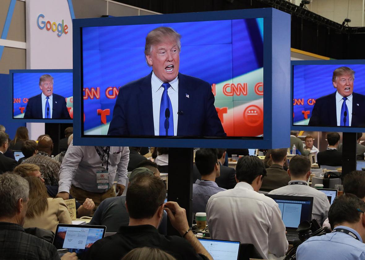 Journalists in the media filing center watch as Republican U.S. presidential candidate Donald Trump is seen speaking on television monitors during the debate sponsored by CNN for the 2016 Republican U.S. presidential candidates in Houston, Texas on Feb. 25.