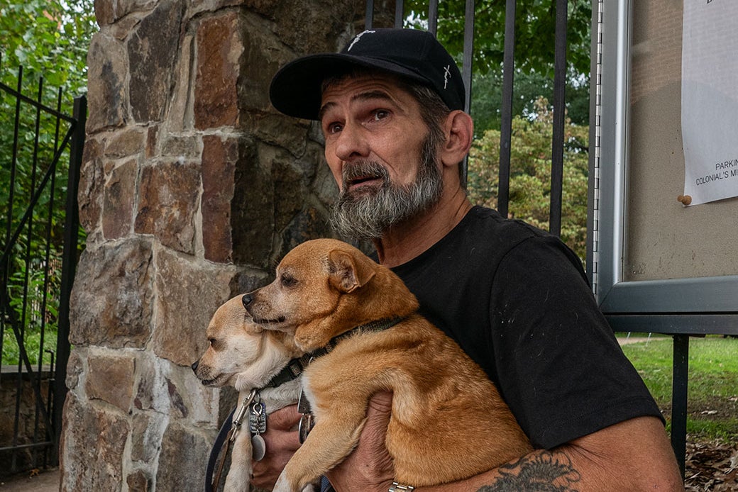 Jeff Padgett, with his dogs Luna and Puppet, sits in the courtyard of Grace Episcopal Church, above Georgetown Ministries.