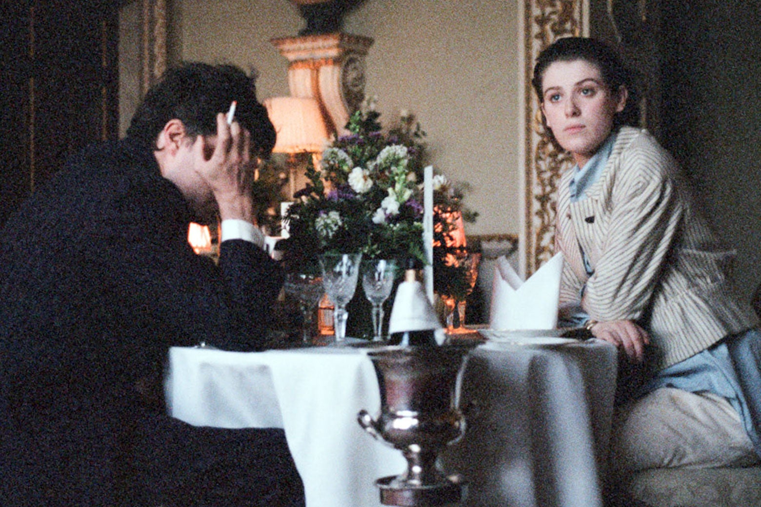 Tom Burke and Honor Swinton-Byrne dine at a fancy establishment in The Souvenir.