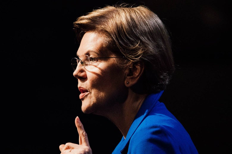 Elizabeth Warren seen in profile with a finger pointing up.