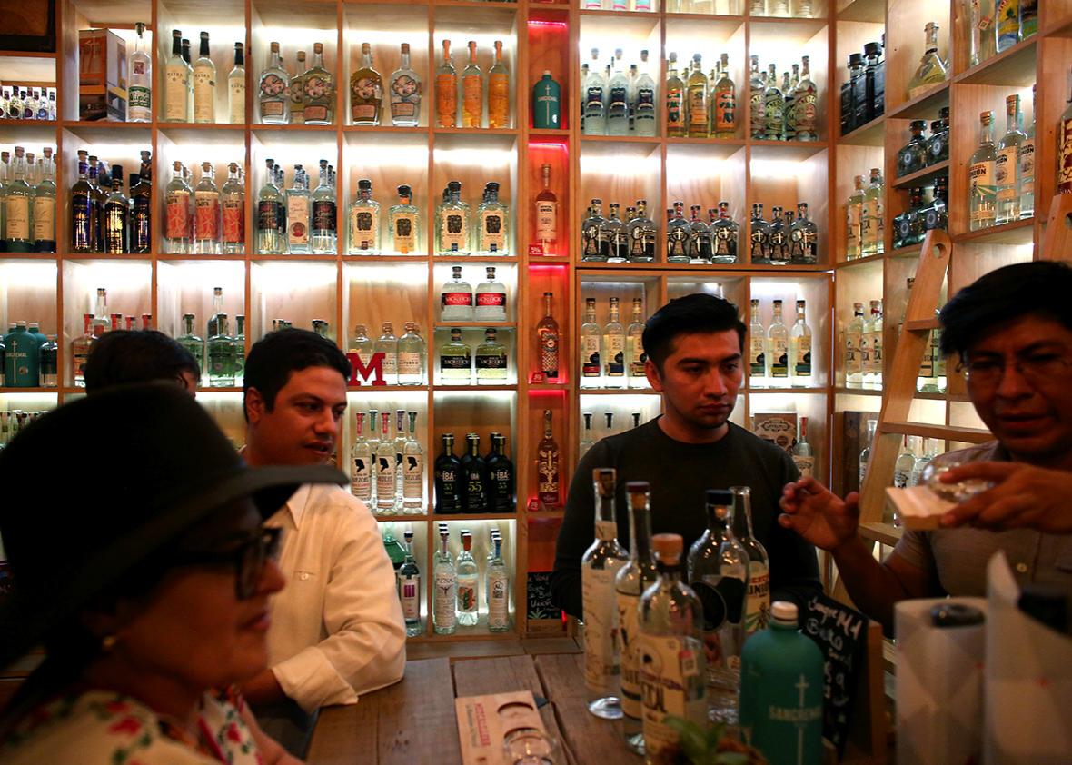 Tourists from Guadalajara sample mezcals at Mezcalilira in Oaxaca City.