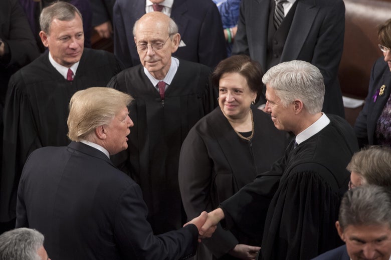 US President Donald Trump shakes hands with Supreme Court Justice Neil Gorsuch (R) alongside US Supreme Court Chief Justice John Roberts (L), Justice Stephen Breyer (2L), and Elena Kagan (2R), during the State of the Union Address before a Joint Session of Congress at the US Capitol in Washington, DC, January 30, 2018. / AFP PHOTO / SAUL LOEB        (Photo credit should read SAUL LOEB/AFP/Getty Images)