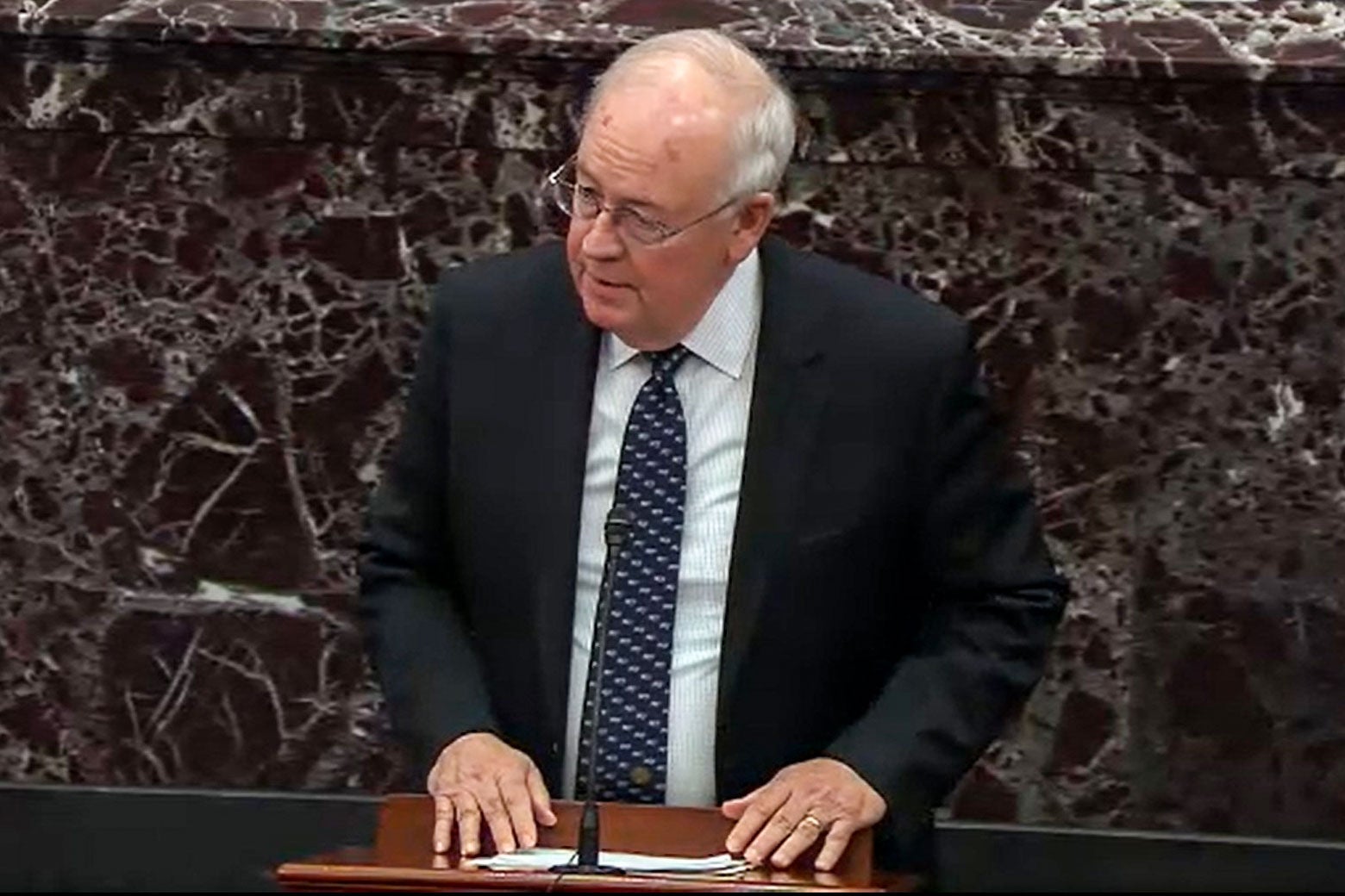 Starr standing at a lectern