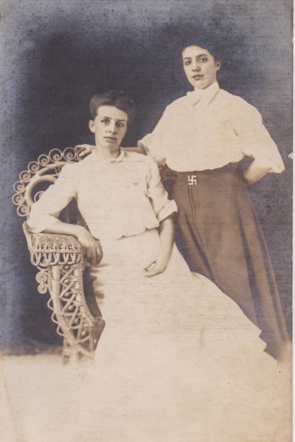 Two young women proudly wearing the swastika logo of the Afrikaner
