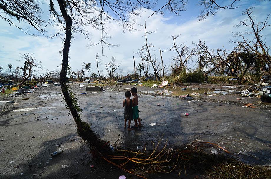 Two young boys look at the devastation in the aftermath of typhoon Haiyan on November 10, 2013 in Tacloban City, Leyte, Philippines.  