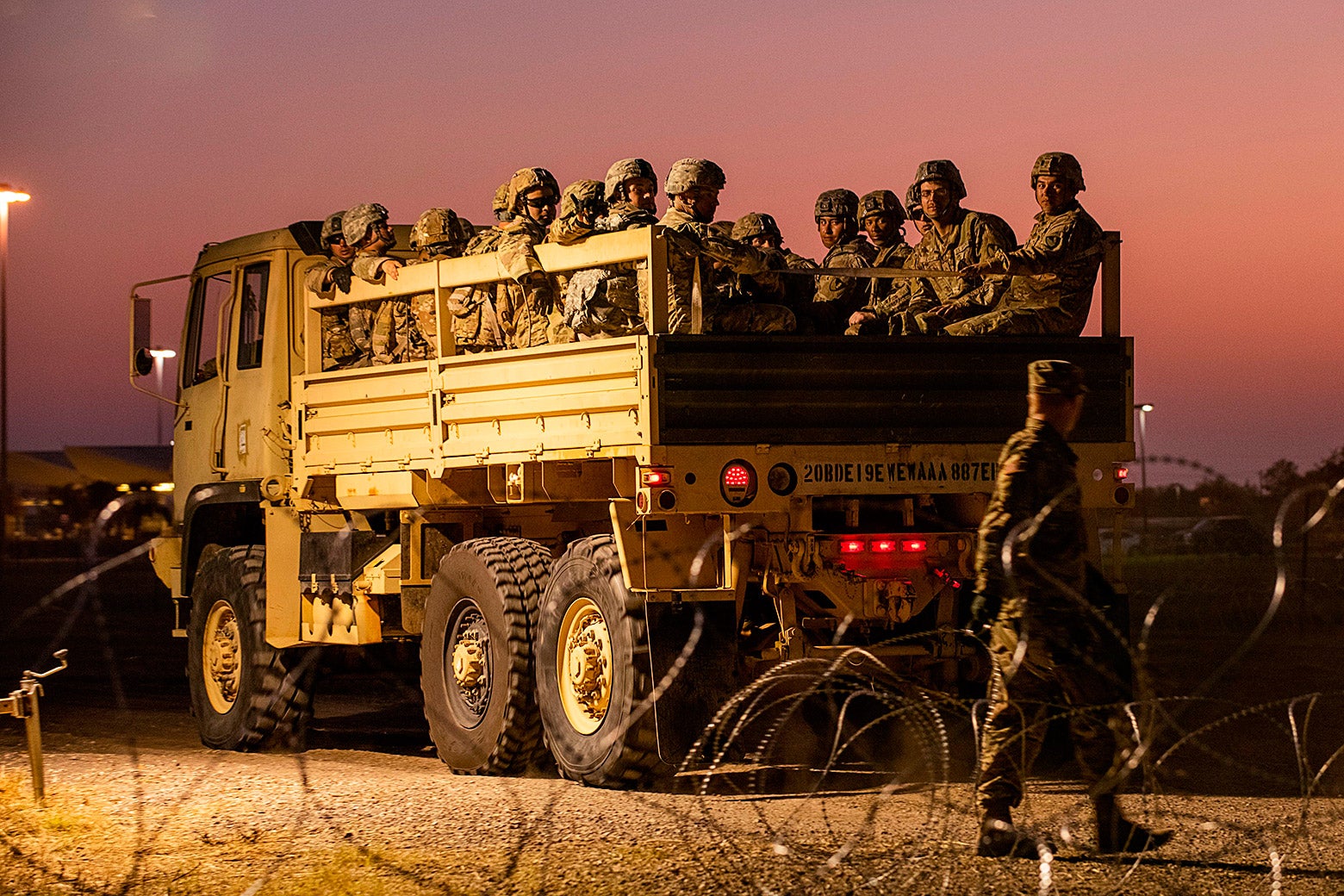 U.S. Army troops enter a compound where the military is erecting an encampment near the U.S.-Mexico border crossing.