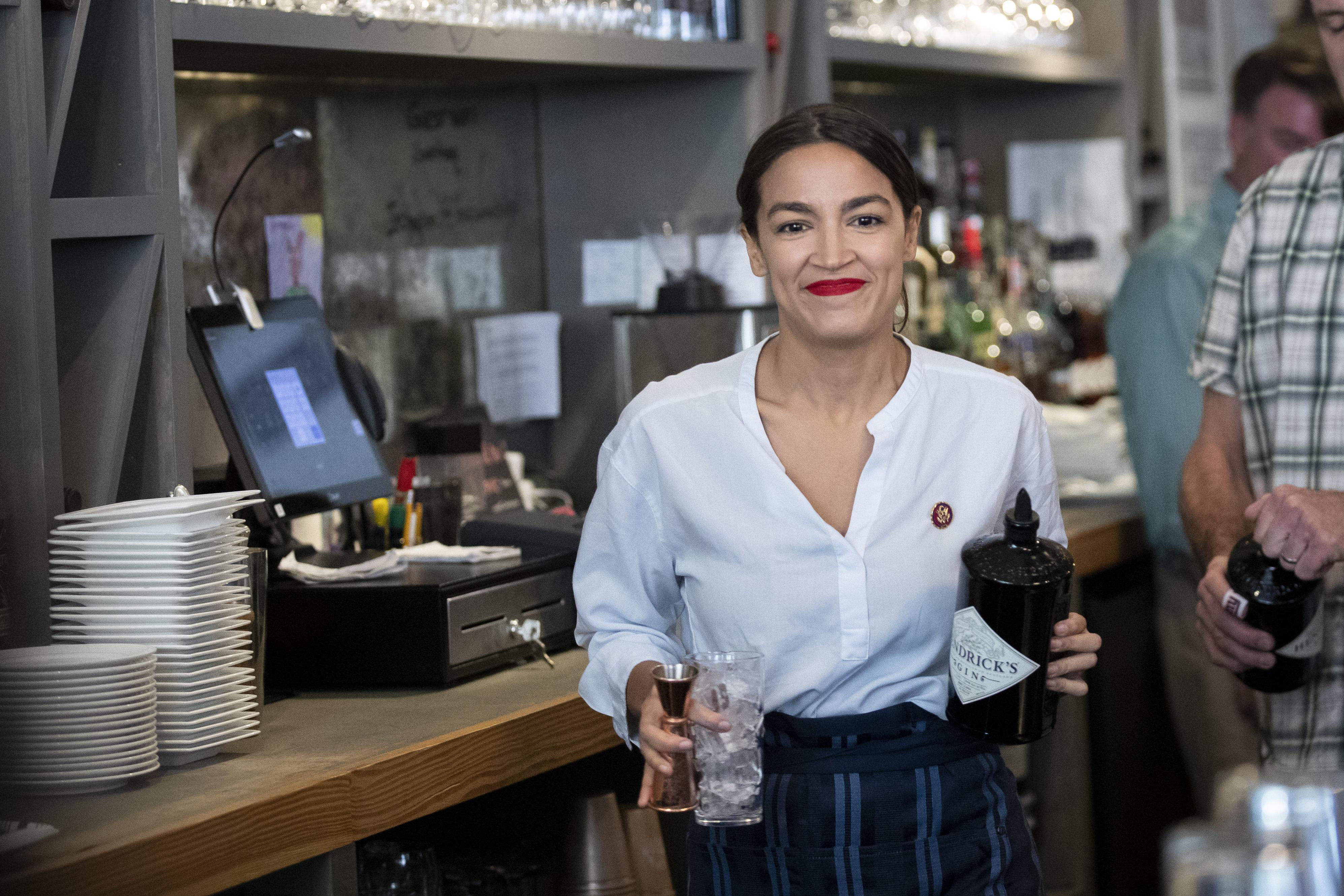 Rep. Alexandria Ocasio-Cortez (D-NY) works behind the bar at the Queensboro Restaurant, May 31, 2019 in the Queens borough of New York City. 
