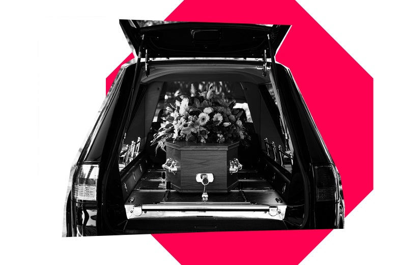 Coffin with flowers on top, in a hearse