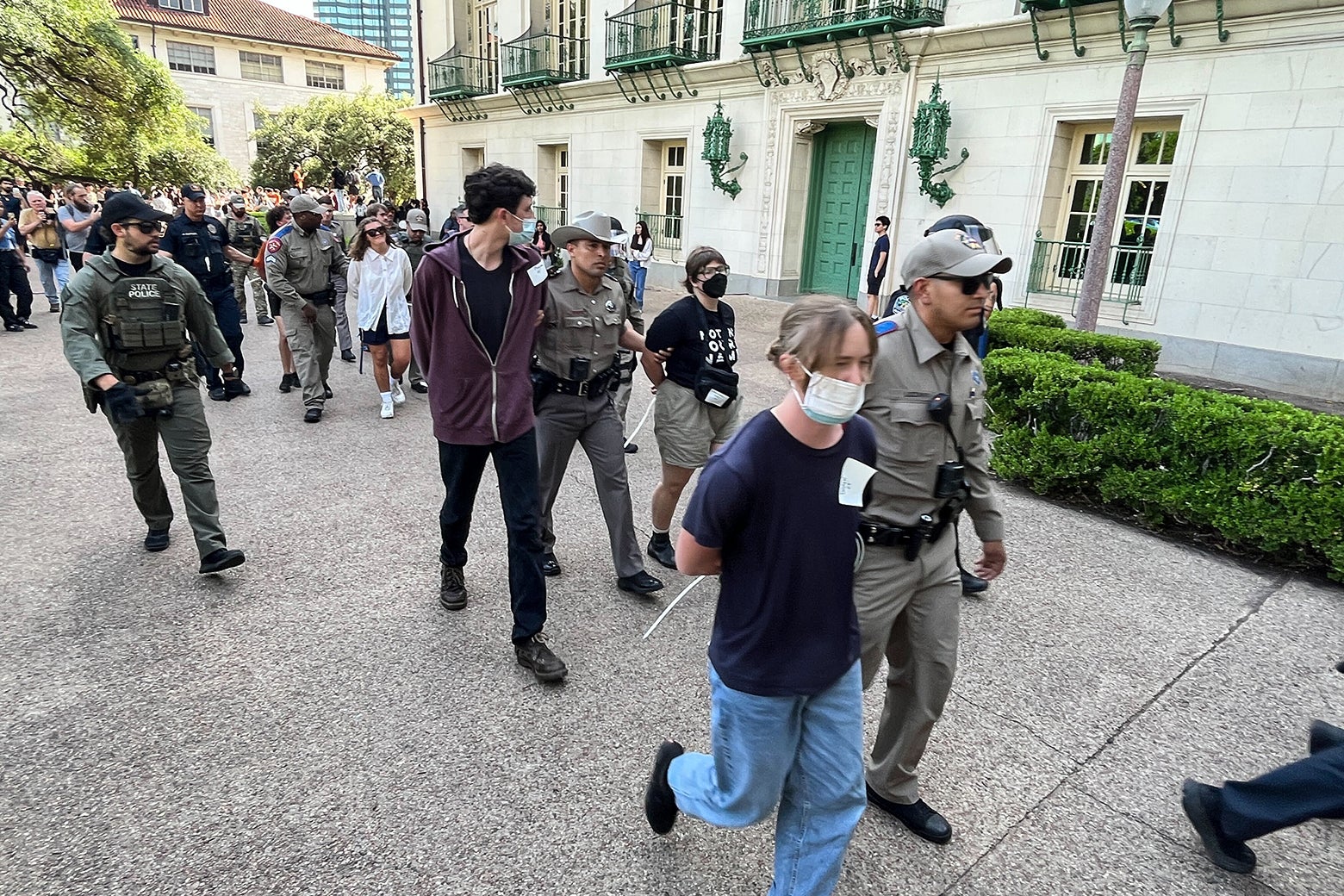 Protestors led away on campus in handcuffs.